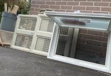 Side view of an awning hopper window sash opened on its top hinge