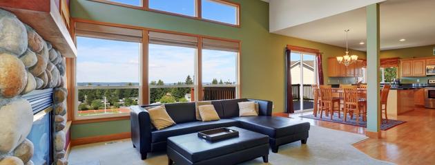 Living room with clerestory windows bringing natural light into a Canadian home with high ceilings