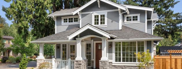 Craftsman-style home exterior with large energy-efficient windows on a sunny day