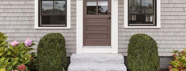 Brown-framed front windows and entry door enhancing a modern home exterior