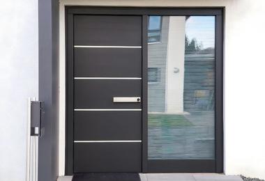 Modern steel front entry door on a residential home, illustrating Ontario front door replacement cost factors in 2026.