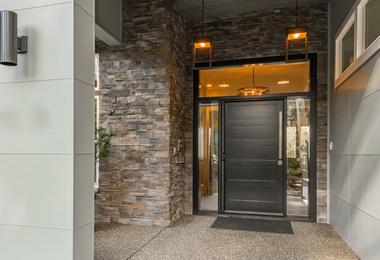 Front door with sidelights adds natural light and curb appeal to a Canadian home entryway