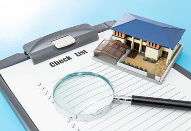 House model with a clipboard checklist, representing a comprehensive home inspection for Canadian homebuyers.
