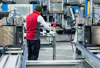Worker manufacturing uPVC window frames in a Canadian window factory