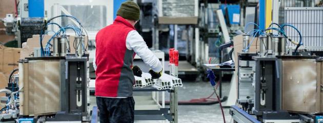 Worker manufacturing uPVC window frames in a Canadian window factory