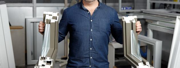 Exterior view of a modern lakefront home in Canada showcasing energy-efficient Low-E glass windows that enhance insulation and natural light.