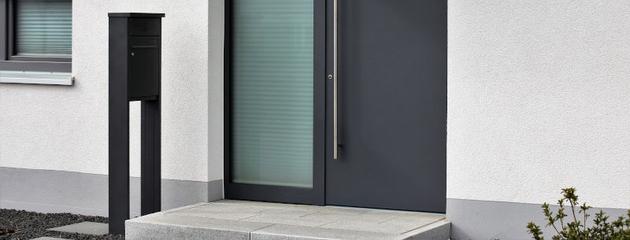 Modern black front door with glass panels and contemporary exterior design