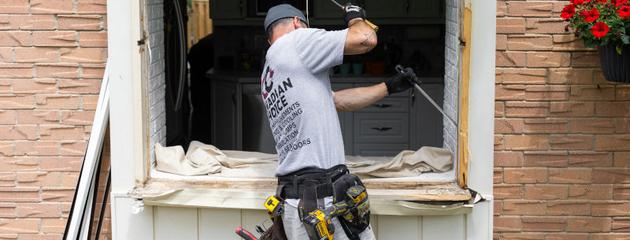 Homeowner reviewing replacement window options for energy-efficient windows in Canada.