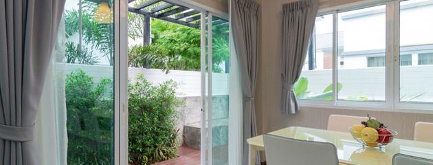Sliding patio door with glass panels in a bright dining room