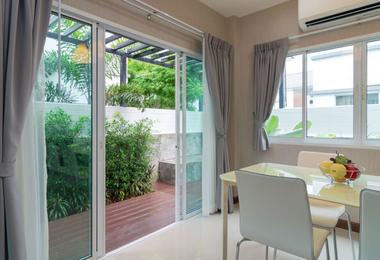 Sliding patio door with glass panels in a bright dining room