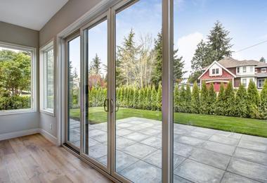 Modern sliding patio doors connecting a contemporary Canadian home to an outdoor patio