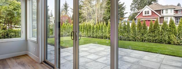 Modern sliding patio doors connecting a contemporary Canadian home to an outdoor patio