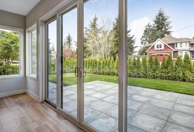 Modern open-concept living room with large sliding patio doors and natural daylight