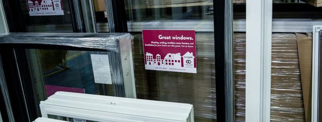 Stacked vinyl window units in a warehouse ready for installation