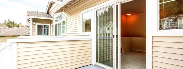Opened standard patio doors leading to a backyard deck in a Canadian home