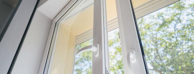 White uPVC window with rigid frame and handle in a home
