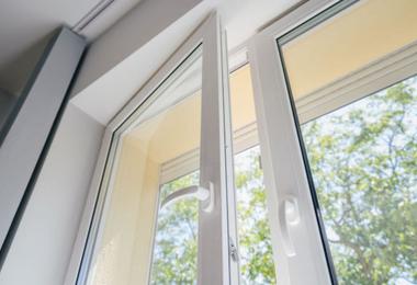 White uPVC window with rigid frame and handle in a home