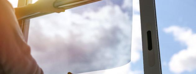 Residential window with privacy film, reducing visibility from outside while allowing natural light