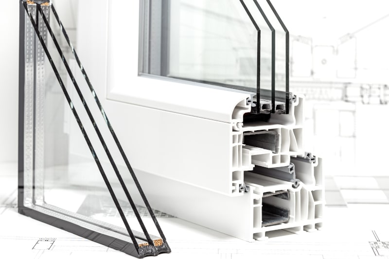 Triple-pane PVC window cross-section with three glass layers and insulated gas cavities