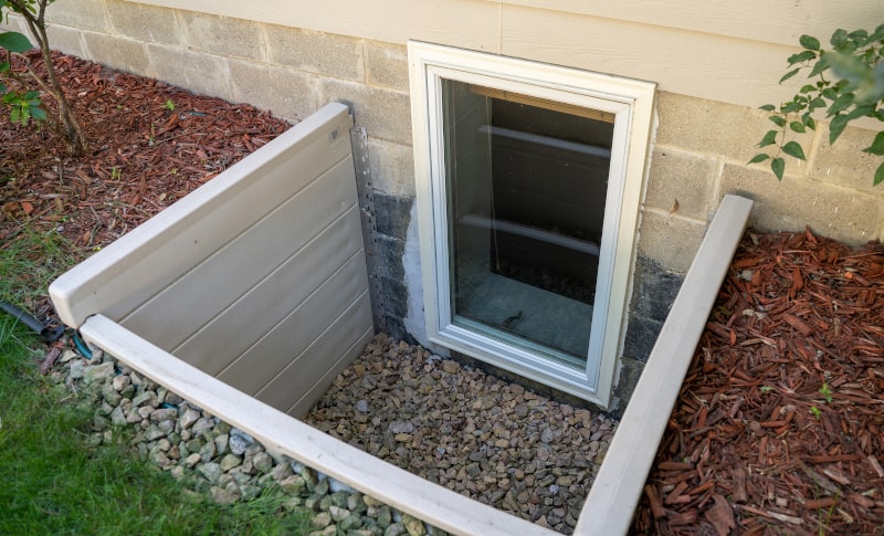 Exterior view of a secure basement window with protective glass
