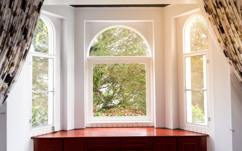 Elegant bow and bay window combination projecting sunlight into a modern Canadian living room