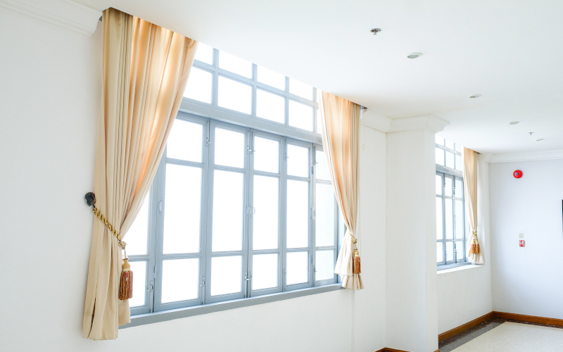 White casement windows opened outward, bringing light and ventilation into a bright home