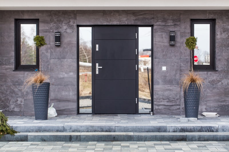 Modern steel exterior door with sleek design and insulated frame installed on a Canadian home