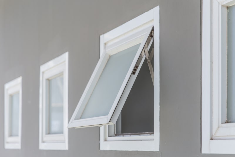 Close-up of open awning window with aluminum frame