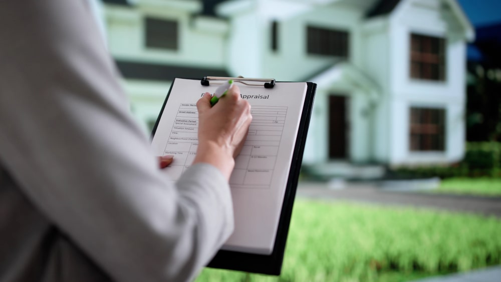 Real estate professional reviewing a detailed home inspection report to help buyers make an informed decision.