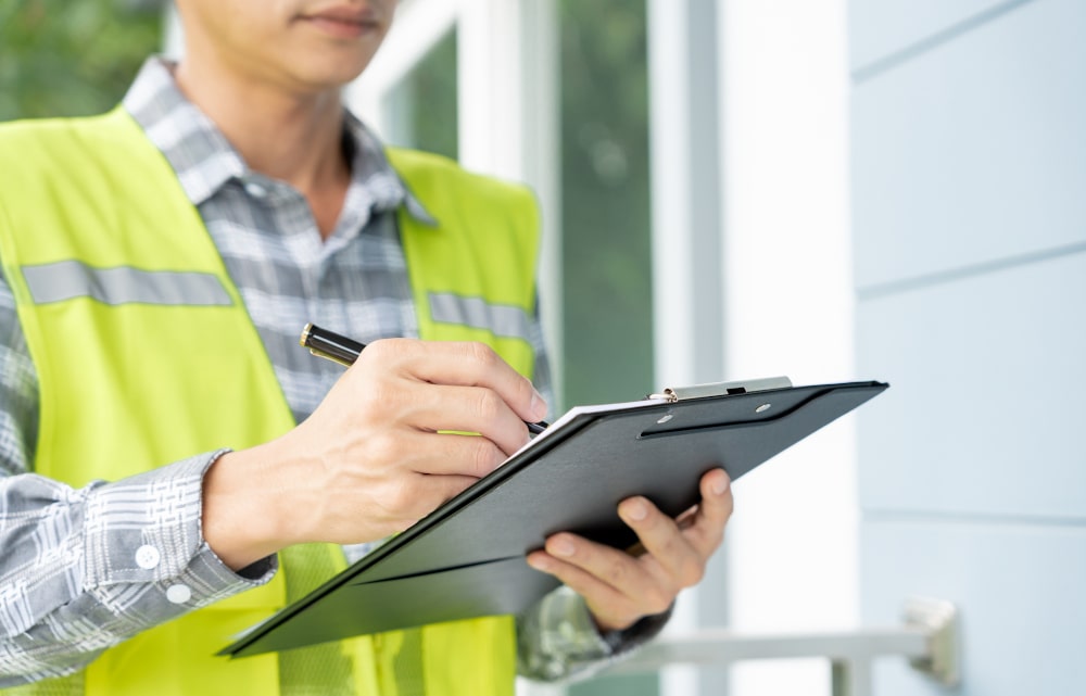 Professional home inspector examining exterior structural elements during a complete home inspection in Canada.