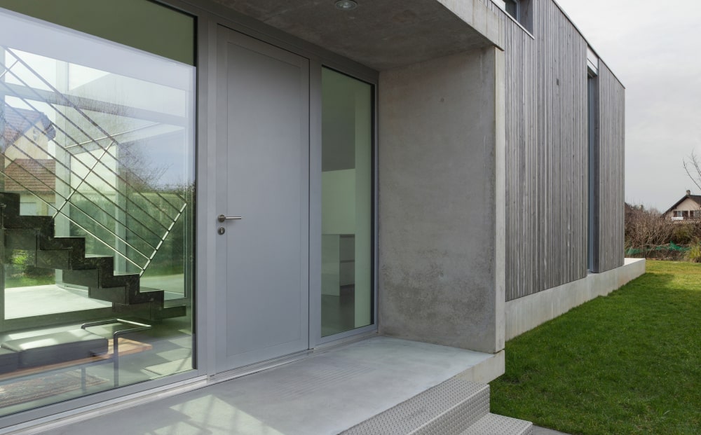 Modern house entrance with an energy-efficient steel front door for cold climates.