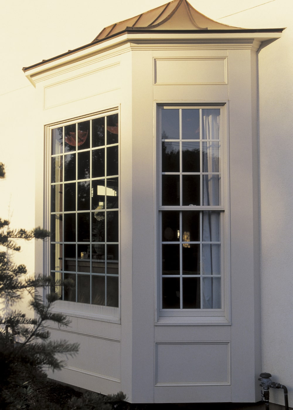 Bay window of a Canadian home with wide panes maximizing natural light