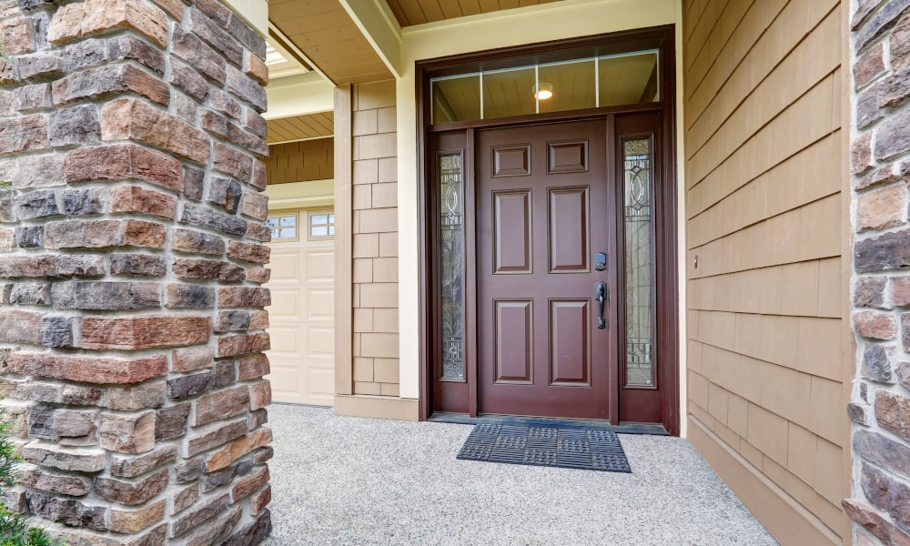 Front door with double sidelights creating a wide, bright, and welcoming home entrance