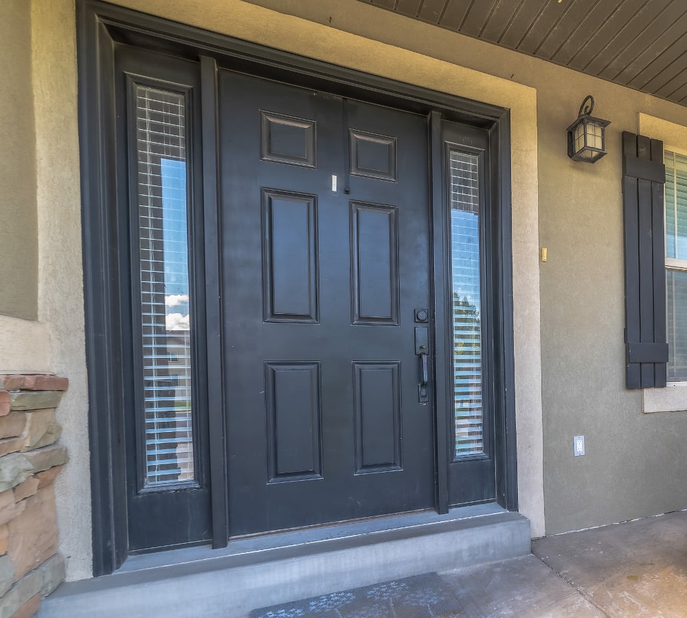 Modern front door with sidelights featuring large glass panels and a contemporary design