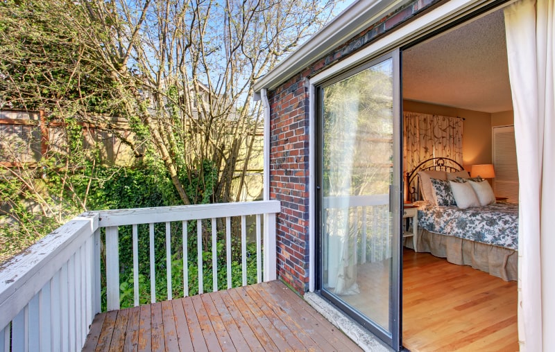 Classic 60-inch sliding patio door commonly used in Canadian homes Standard sliding patio door with two large glass panels and white vinyl frame