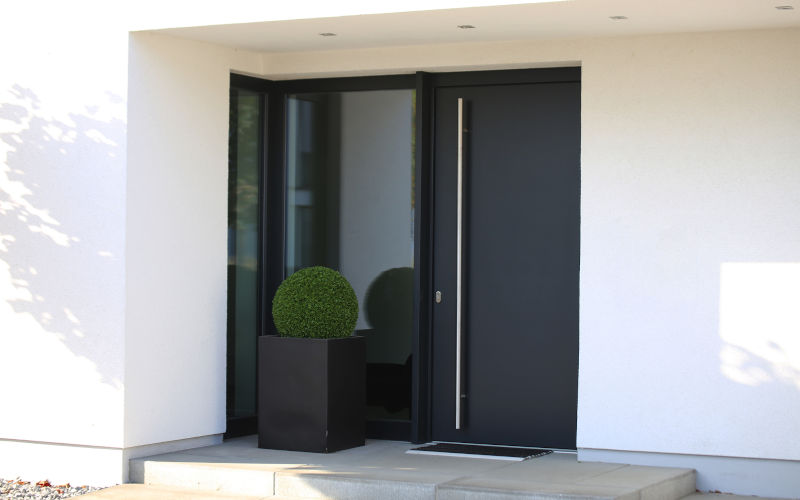 Modern front door with contemporary hardware illustrating how proper lock installation and reinforced door construction support long-term durability.