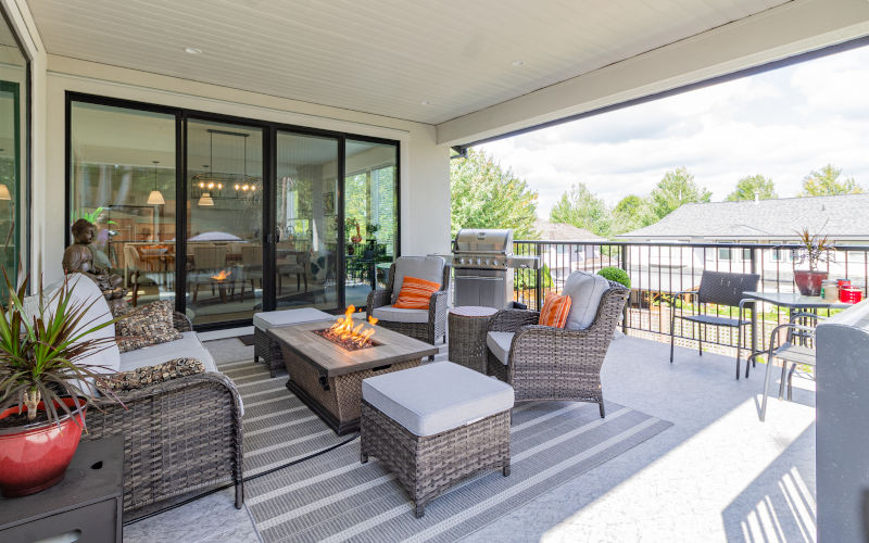 Outdoor deck area with stylish patio sliding doors leading to an exterior space, featuring elegant furniture — great for illustrating patio door options.