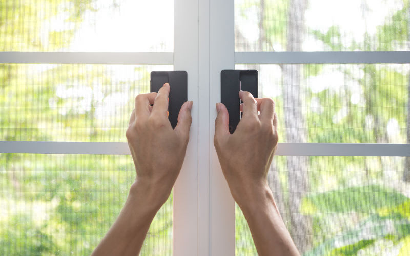 Retractable screen mounted on window frame during professional installation