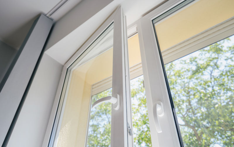 Opened vinyl PVC window in modern apartment interior showing installation quality and frame design