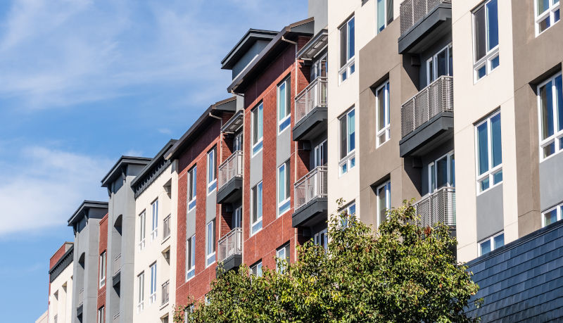 Modern multi-story residential building with large windows, illustrating window configuration strategies for multi-level homes