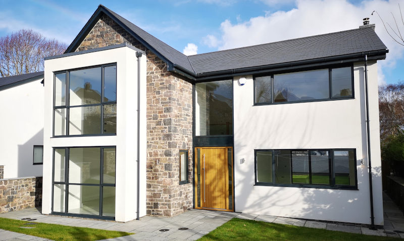 Large modern detached home with updated windows, representing increased property value and improved curb appeal