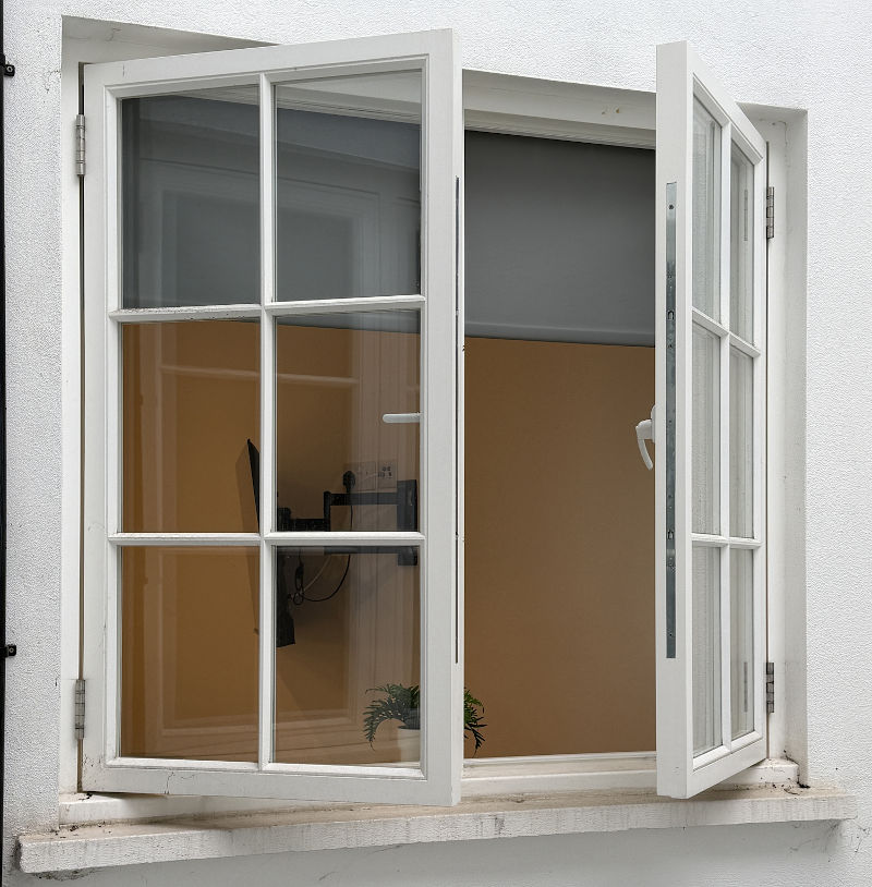 Casement windows open outward to provide ventilation in a residential home.