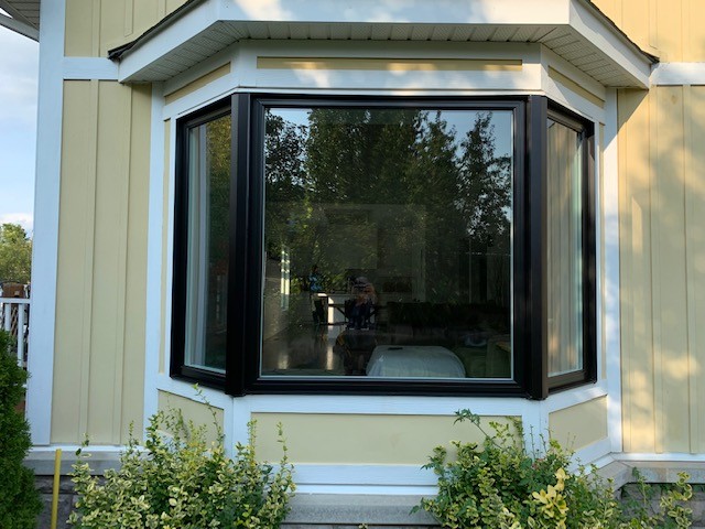 Bay and bow windows extending outward to increase natural light and space in Canadian homes.