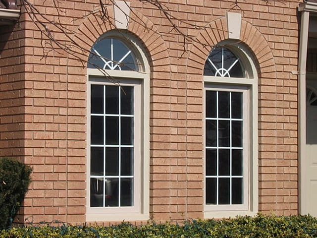 Custom-shaped windows, including arched and geometric designs used in Canadian homes.
