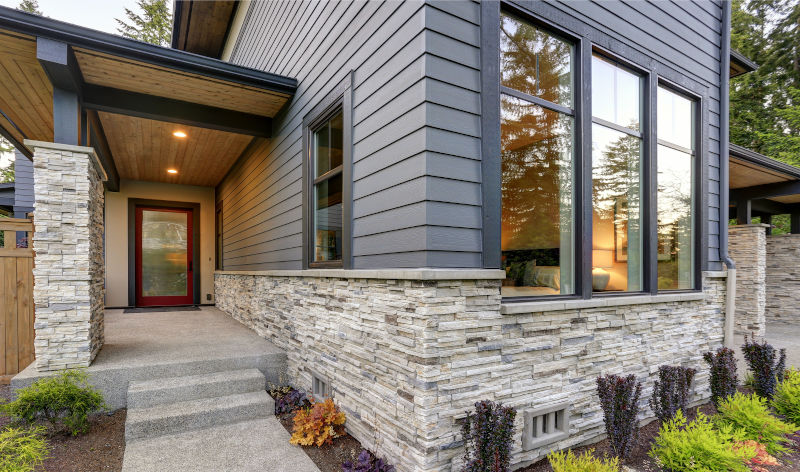 Modern house with black-framed windows creating contrast and a contemporary exterior design.
