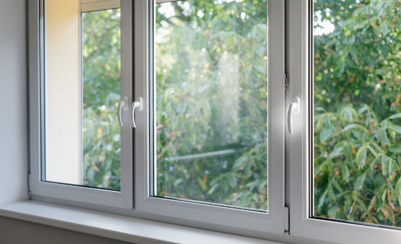 Close-up of a modern white window frame showing sill and drainage area for identifying potential weep hole issues