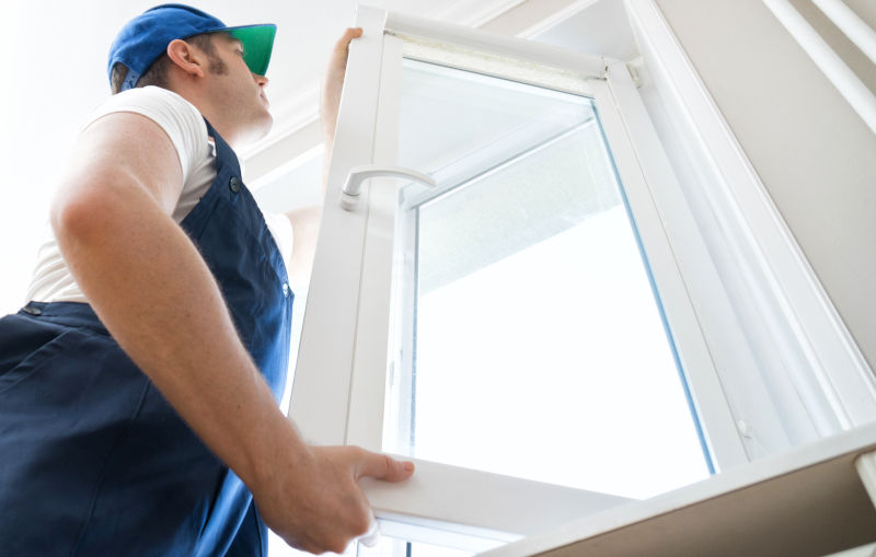 A professional installing a residential window frame, ensuring proper sealing and long-term durability