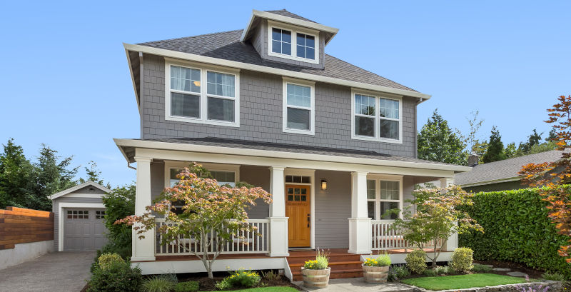 Luxury home exterior with well-maintained windows illustrating proper care for long-term window performance