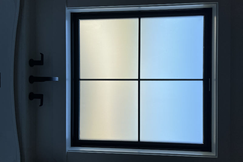 Frosted shower window with privacy glass providing natural light while maintaining bathroom privacy