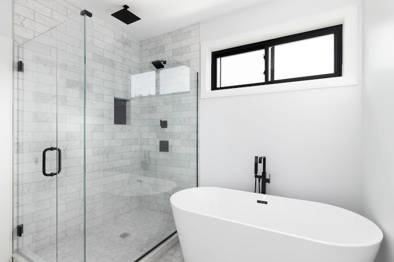 High horizontal shower window above a walk-in shower providing natural light and privacy in a modern bathroom